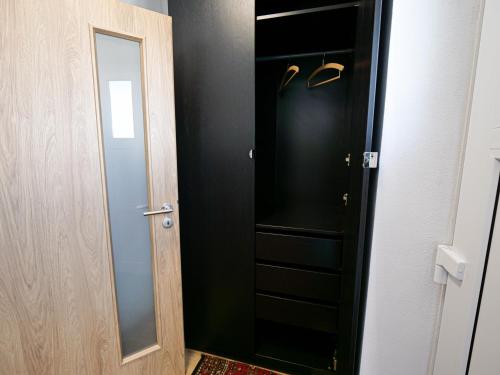 a black closet with a mirror next to a door at Chaloupka Na Pivovaře Seč in Seč