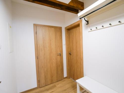 an empty room with a wooden door and a bench at Chaloupka Na Pivovaře Seč in Seč