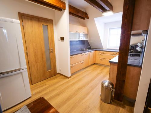 a kitchen with wooden floors and a door to a room at Chaloupka Na Pivovaře Seč in Seč