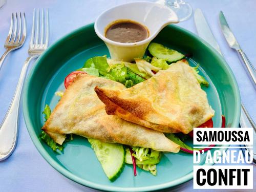 a green plate with a sandwich and salad and a cup of sauce at Château Corneille in Vieux-Villez