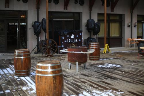 a stage with barrels and a table in a building at Duja Chalet Ski Center in Sarıkamıs
