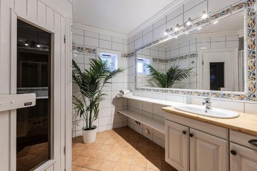 a bathroom with a sink and a large mirror at Tinden Apartments in Hemsedal