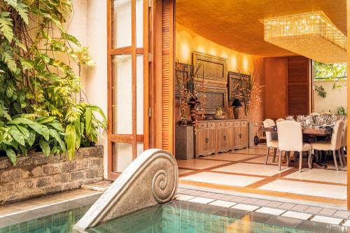a house with a swimming pool and a dining room at Ishq Colombo in Colombo