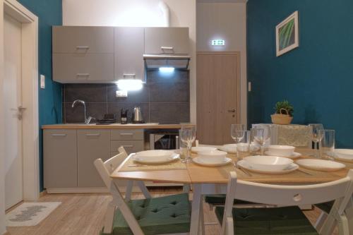 a dining room with a wooden table and a kitchen at You & Me Cozy Apartments in Athens