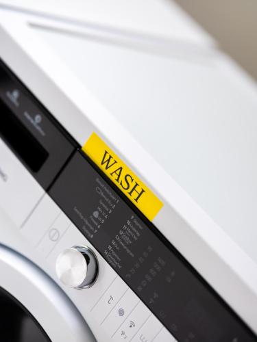 a close up of a washing machine with the words wash at Trolltunga Hostel in Tysso