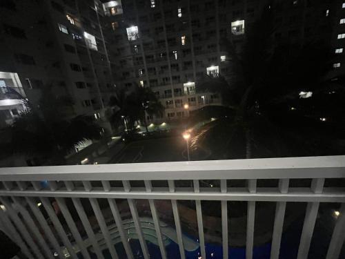 a view from the balcony of a building at night at 4Brother's Staycation by Jessika in Manila