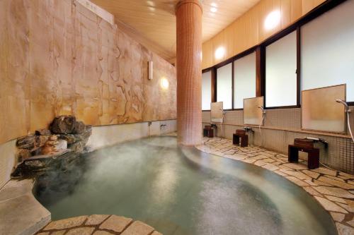 a large pool of water in a bathroom at Yamayuri no Yado in Hanamaki