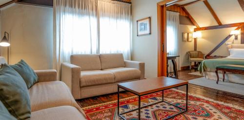 a living room with a couch and a bed at Hotel Alcazar Irun in Irún