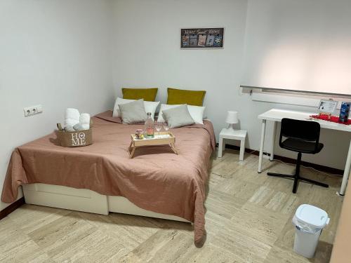 a bedroom with a bed with a tray on it at Moderna habitación en el corazón de Alicante in Alicante
