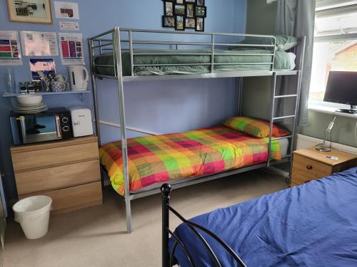 a bedroom with two bunk beds and a bed at Mudeford Swans in Christchurch