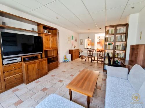 a living room with a large flat screen tv at Holiday House Srečka in Izola