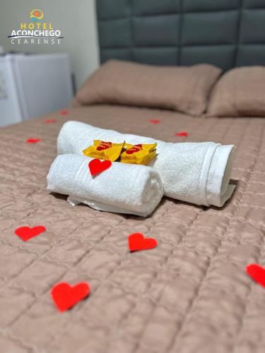 a couple of towels with hearts on a bed at Hotel Aconchego Cearense in Fortaleza
