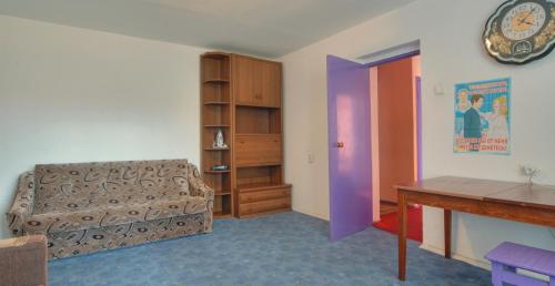 a living room with a couch and a clock on the wall at Квартира по улице Большая Васильковская, 114 in Kyiv
