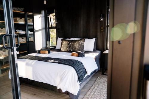 Un pat sau paturi într-o cameră la Klein-Hangklip