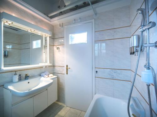 a bathroom with a sink and a shower at Yianni's Home-Comfort Apartment in Volos in Volos