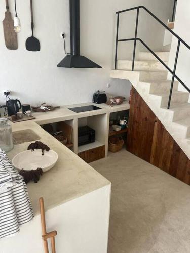 a bathroom with a sink and a staircase with a stair case at Casa Olarias in Grândola