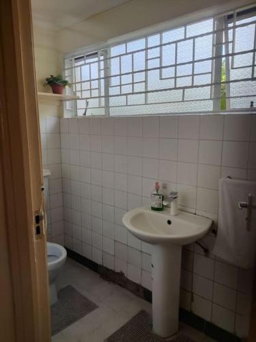a bathroom with a sink and a toilet at Townhouse Upper Hill Nairobi 2 in Nairobi