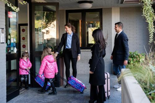 a group of people standing outside a building with luggage at EcoHotel Ristorante Milano in Borgo a Mozzano