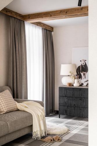 a living room with a couch and a window at Owce Dwie in Zakopane