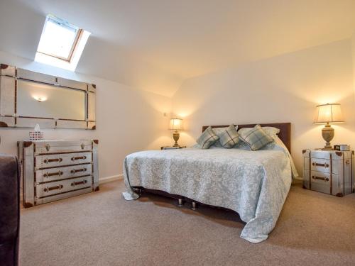 a bedroom with a bed and a dresser and a mirror at 1 bed property in Filey 79278 in Wold Newton