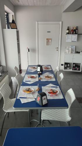 a long blue table with white chairs around it at Nautica Tarello - Casa Ena BeB in Viverone