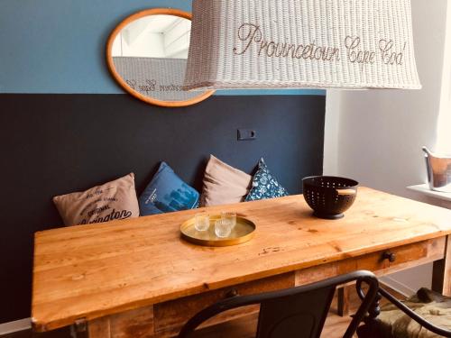a dining room table with a mirror and pillows at Charmantes Stadthaus in Waldshut-Tiengen