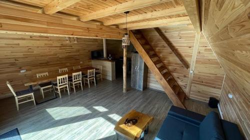 Zimmer im Dachgeschoss mit einem Tisch und Stühlen in der Unterkunft Cabana Armonia Naturii in Avrig