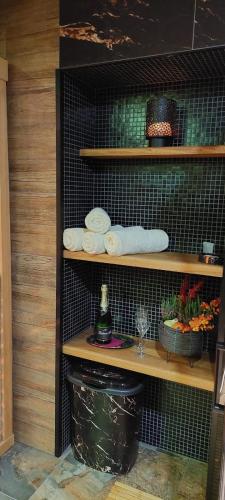 a black shelf with dishes and plates on it at Rodinný pension U Soudku in Rudník