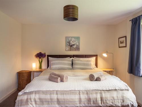a bedroom with a large bed with towels on it at 1 bed in Builth Wells BN201 in Aberedw