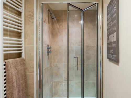 a shower with a glass door in a bathroom at 1 bed in Builth Wells BN201 in Aberedw