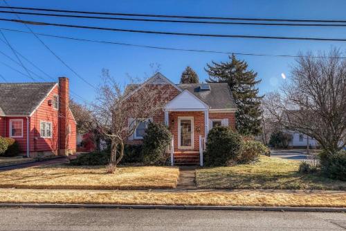 a house with a red house at Family Home near NY Beach - Private Workspace in Glen Head