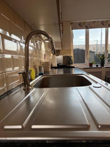 a kitchen sink with a faucet on top of it at 3-Bedroom Apartment In The Heart of London in London