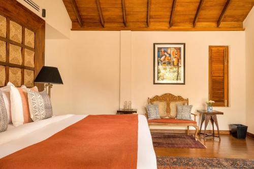 a bedroom with a bed and a chair at Ishq Colombo in Colombo