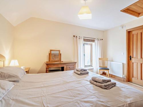 a bedroom with a large white bed with towels on it at 1 bed property in Tretower Brecon Beacons BN126 