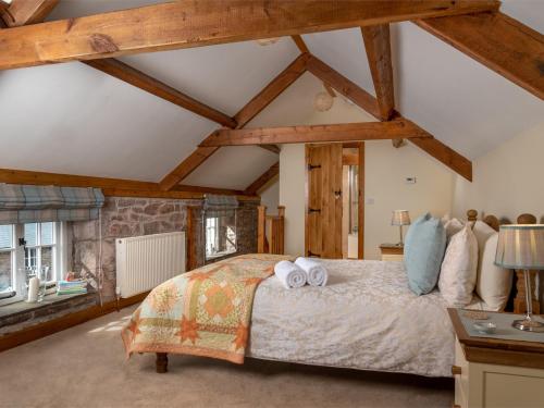 a bedroom with a large bed with wooden beams at 1 Bed in Bwlch BN270 in Llansantffread