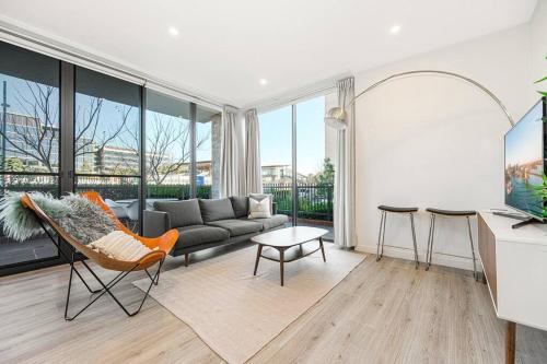a living room with a couch and a table at Penrith 3Br apt close toTrain station & Shopping in Penrith