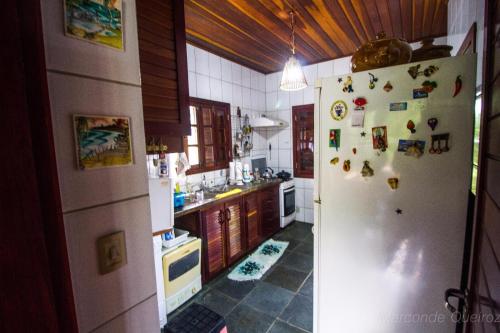 a kitchen with a refrigerator with magnets on it at 3QUARTOS PIPA4YOU in Pipa