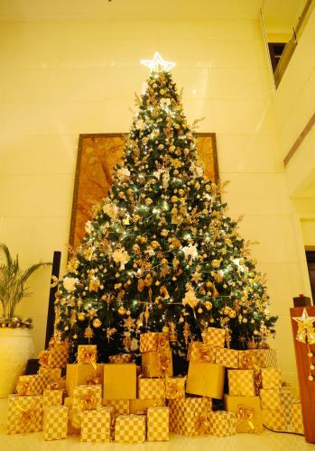 a christmas tree and a pile of presents under it at The Ritz-Carlton, Bangalore in Bengaluru