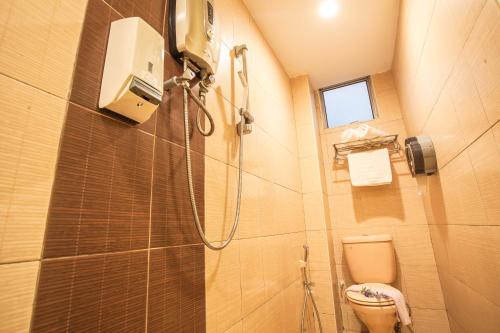 y baño con ducha y aseo. en Lavender Inn Nusa Bestari en Johor Bahru