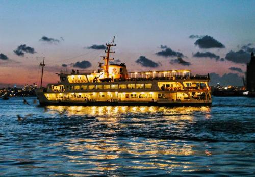 a large boat in the water at night at İmmortal Hotel İstanbul in Istanbul