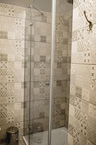 a shower with a glass door in a bathroom at Apartament Komnata in Wünschelburg