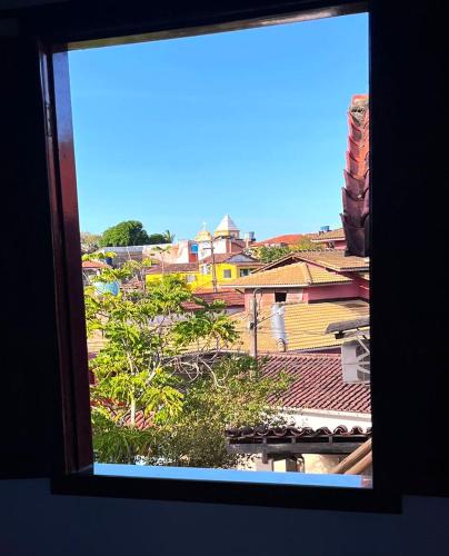 a view of a city from a window at Hospedaria Mucugê - na principal rua da cidade, Rua do Mucugê - Arraial d'Ajuda in Arraial d'Ajuda