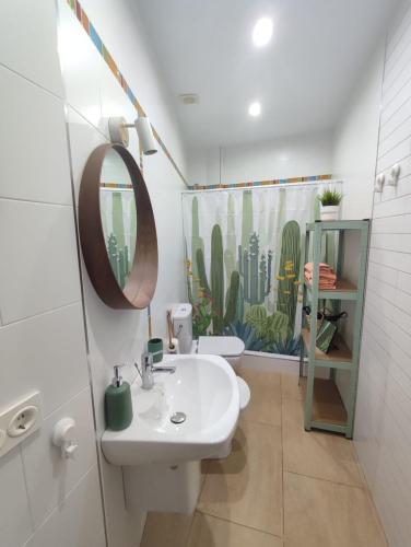 a bathroom with a sink and a shower curtain at VISTA ALMIJARA in Frigiliana