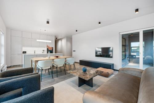 a living room with a couch and a table at Harbour Lux 3BR & 2BA in the Heart of the City with Free Parking in Reykjavík