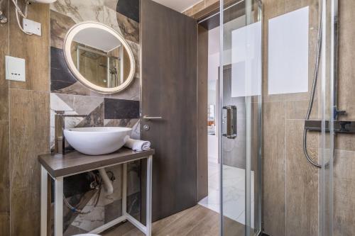 a bathroom with a sink and a mirror at Studio Penthouse with kitchenette and side seaview at the new Olo living in Paceville