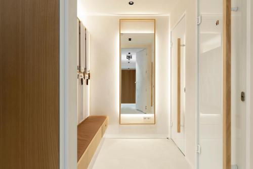 a hallway with a mirror and a dressing room at Elite Apartments Brzeźno Premium in Gdańsk