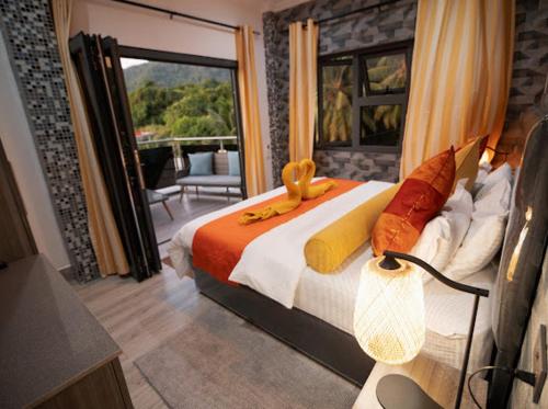 a bedroom with a large bed and a balcony at 360 Degrees Villa in Victoria