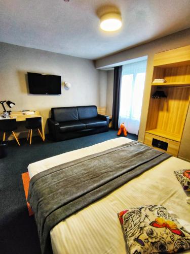 a hotel room with a bed and a couch at Best Western Hotel De Paris in Laval