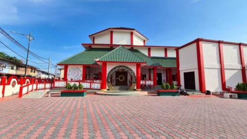 a red and white building on a brick road at Pangkor BeachWalk Studio in Pangkor