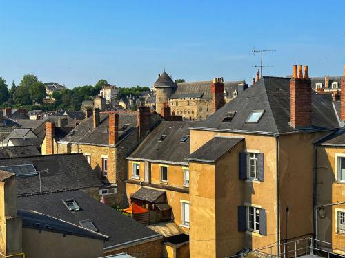 a view of roofs of houses in a city at Best Western Hotel De Paris in Laval